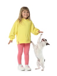 Image of Cute child and playful dog on white background. First pet