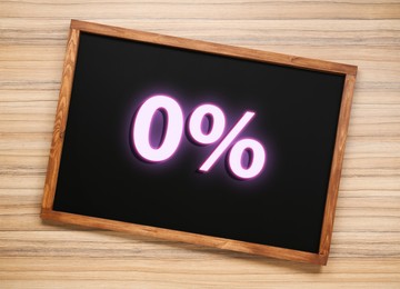 Image of Zero percent commission. Chalkboard with 0% on wooden background, top view