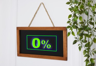 Image of Zero percent commission. Chalkboard with 0% hanging on door