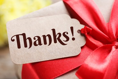 Image of Thank tag attached to gift box, closeup