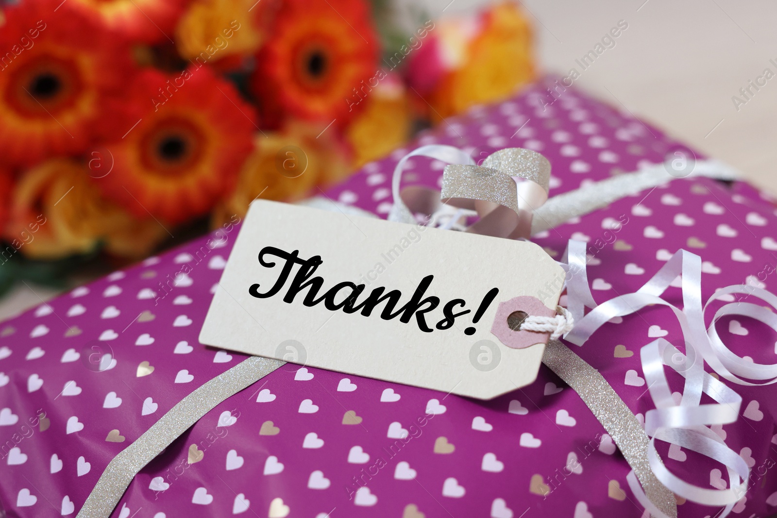 Image of Thank tag attached to gift box, closeup