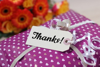 Image of Thank tag attached to gift box, closeup