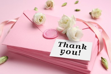 Image of Thank card, flowers and letters on pink background