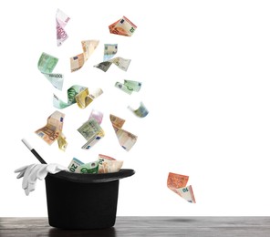 Image of Money flying out of magician's hat against white background