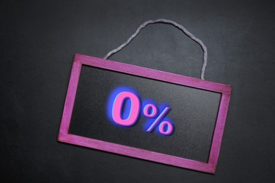 Image of Zero percent commission. Chalkboard with 0% on black background, top view