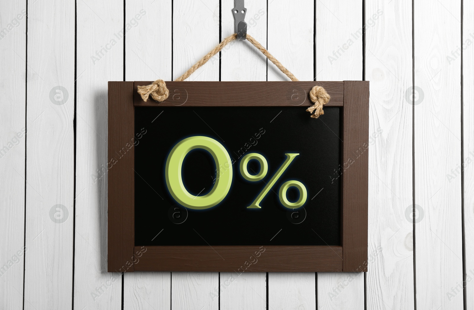 Image of Zero percent commission. Chalkboard with 0% hanging on white wooden wall