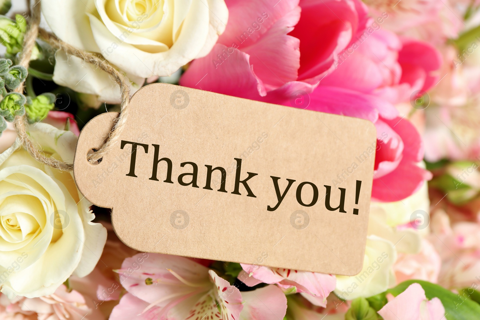 Image of Thank tag and bouquet of flowers , closeup
