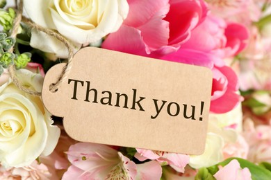 Image of Thank tag and bouquet of flowers , closeup