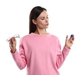 Photo of Woman choosing between glasses and contact lenses on white background
