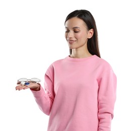 Photo of Woman choosing between glasses and contact lenses on white background
