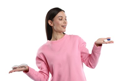 Photo of Woman choosing between glasses and contact lenses on white background