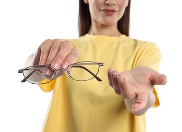 Photo of Woman choosing between glasses and contact lens on white background, closeup