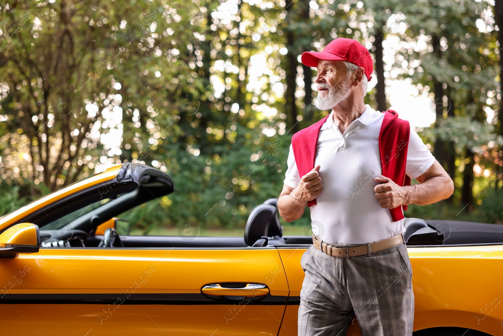 Photo of Stylish senior man near modern cabriolet outdoors