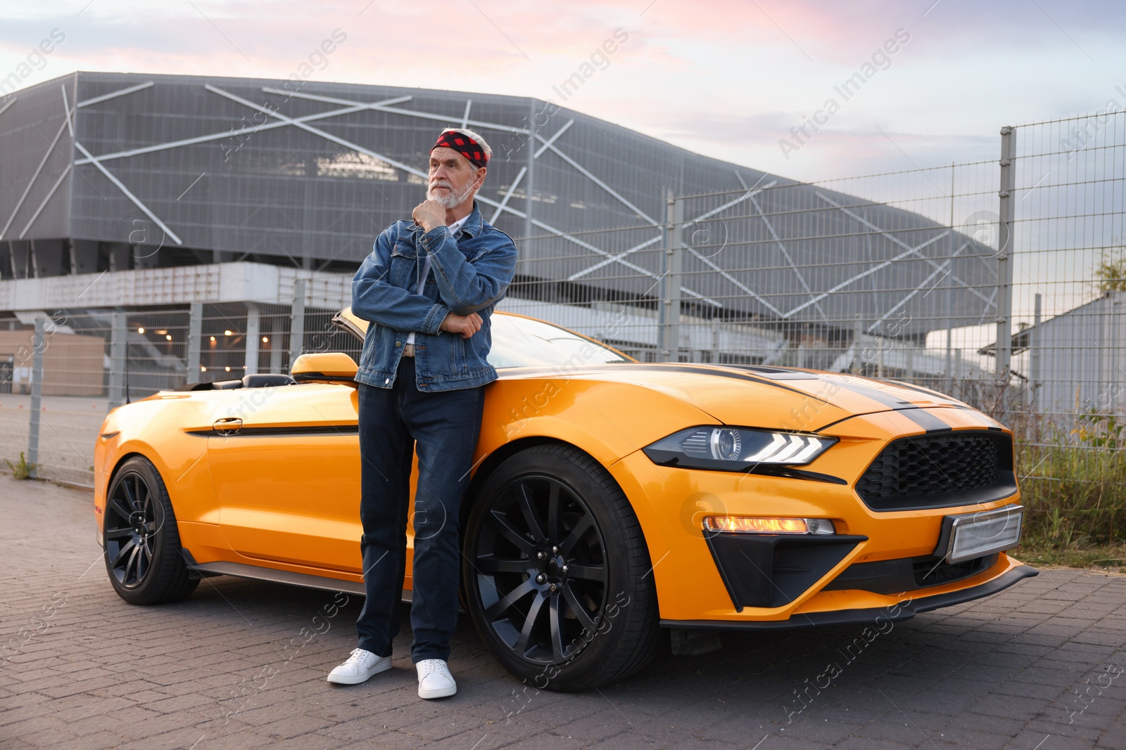 Photo of Stylish senior man near modern cabriolet outdoors