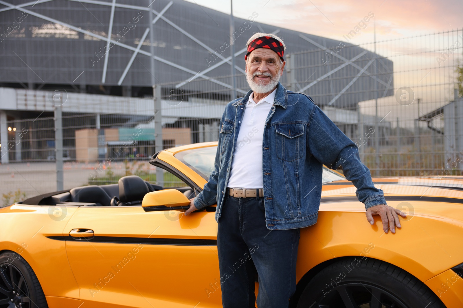 Photo of Stylish senior man near modern cabriolet outdoors