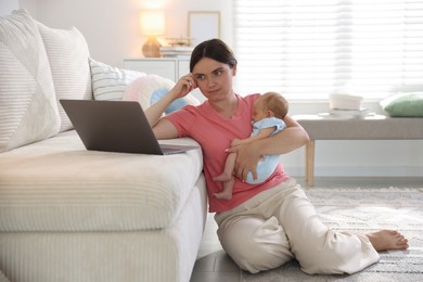 Photo of Telehealth. Mother with her baby leaning on sofa and having online consultation with doctor at home