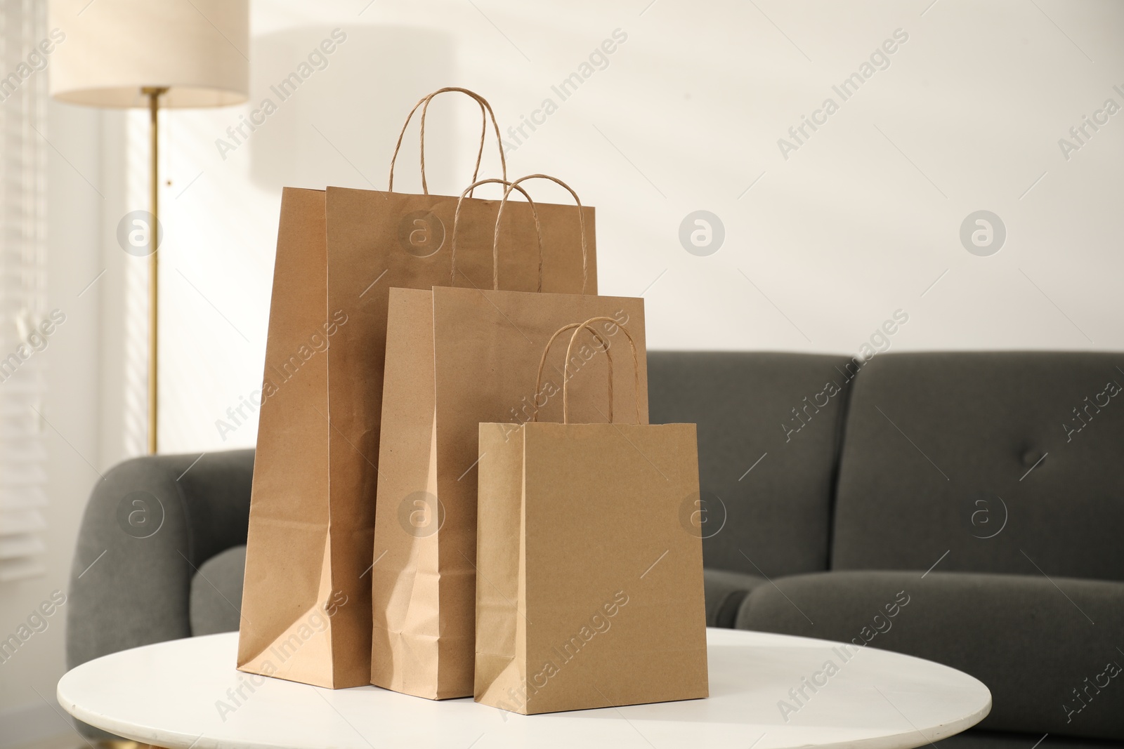 Photo of Paper bags on white table indoors, closeup