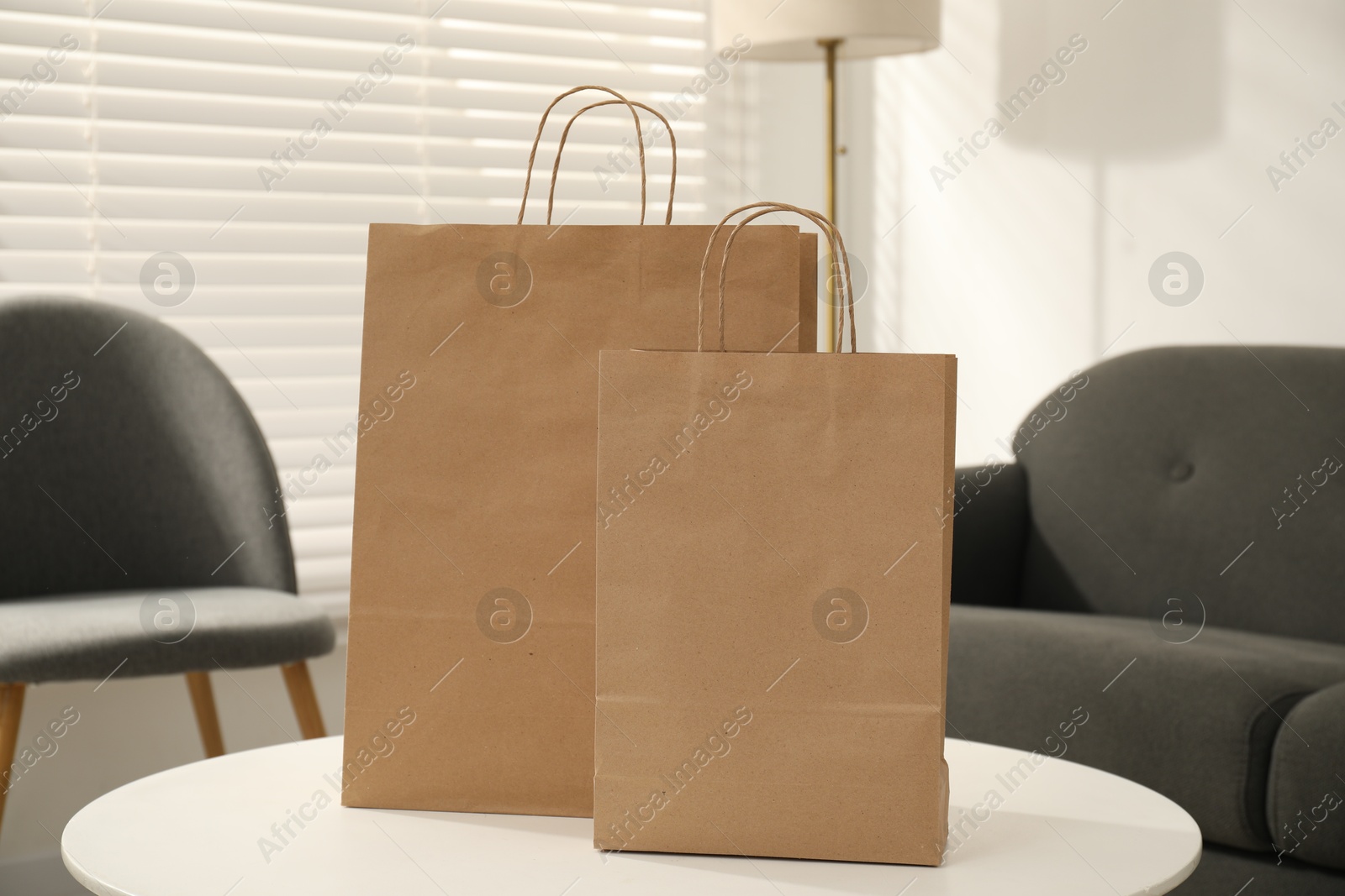 Photo of Paper bags on white table indoors, closeup