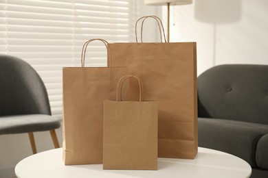 Photo of Paper bags on white table indoors, closeup