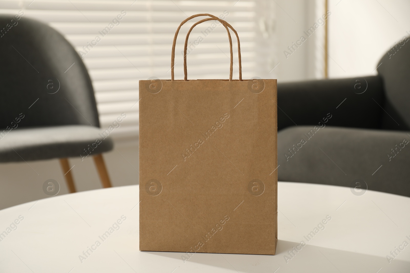 Photo of Paper bag on white table indoors, closeup