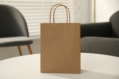 Photo of Paper bag on white table indoors, closeup