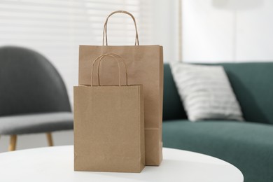 Photo of Paper bags on white table indoors, closeup. Space for text