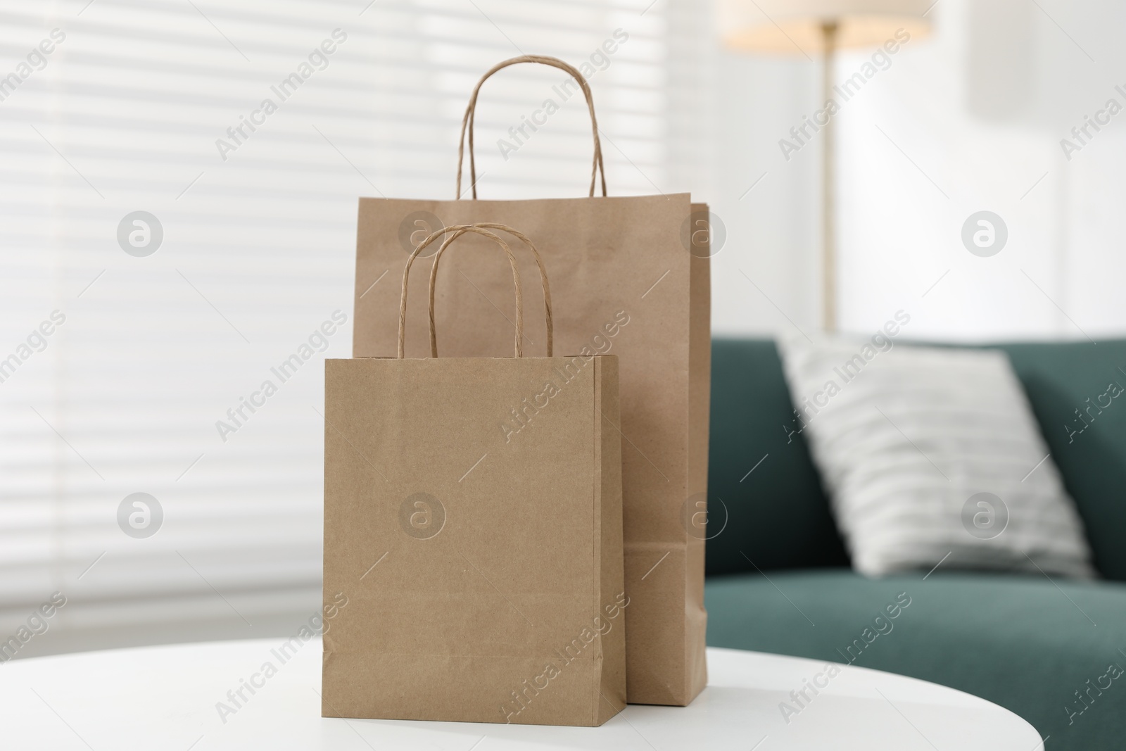 Photo of Paper bags on white table indoors, closeup