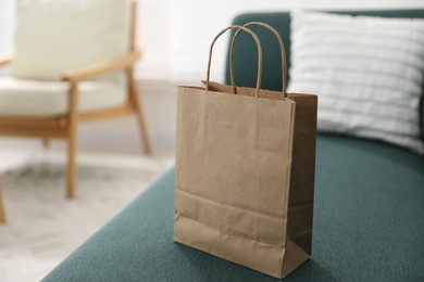 Photo of Paper bags on sofa indoors, closeup. Space for text