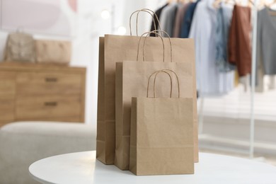Photo of Paper bags on white table indoors, closeup