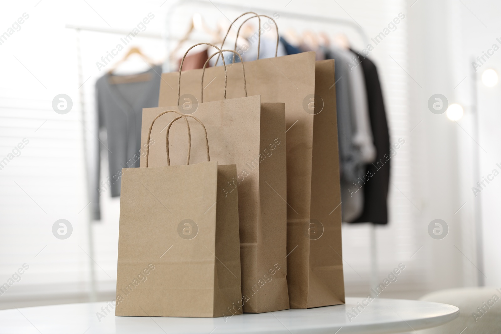 Photo of Paper bags on white table indoors, closeup