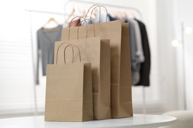 Photo of Paper bags on white table indoors, closeup