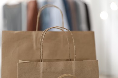 Photo of Paper bags with handles against blurred background, closeup