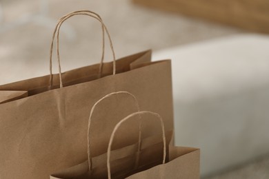 Photo of Paper bags against blurred background, closeup. Space for text