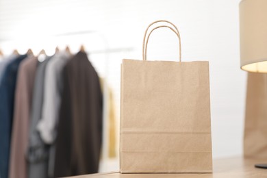 Photo of Paper bag on counter indoors, closeup. Space for text