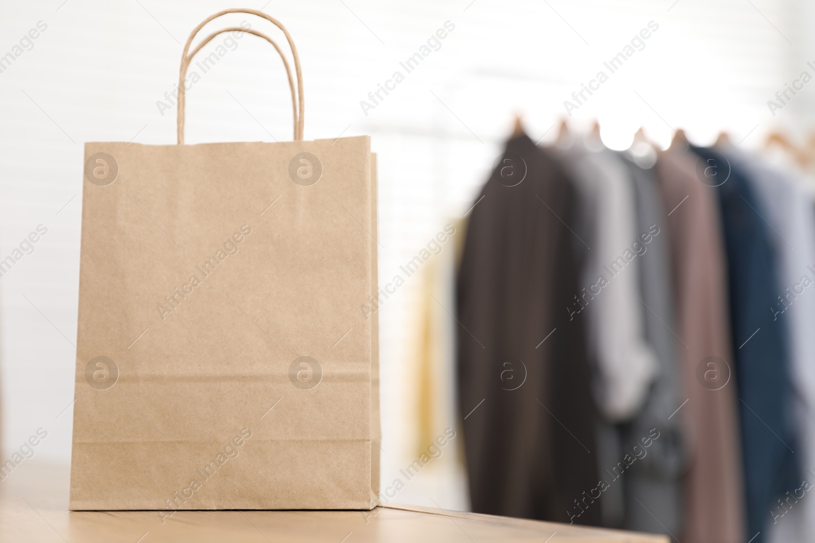 Photo of Paper bag on counter indoors, closeup. Space for text