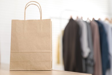 Photo of Paper bag on counter indoors, closeup. Space for text