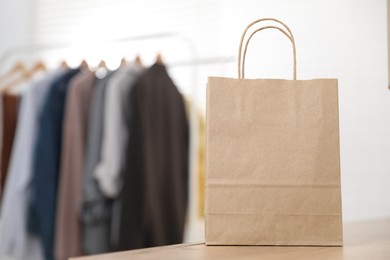 Photo of Paper bag on counter indoors, closeup. Space for text