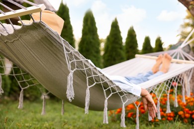 Photo of Senior woman resting in hammock outdoors, selective focus