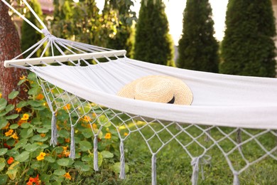 Photo of One straw hat on hammock in garden