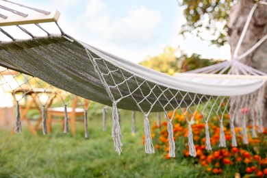 Photo of Empty comfortable white hammock in garden, closeup