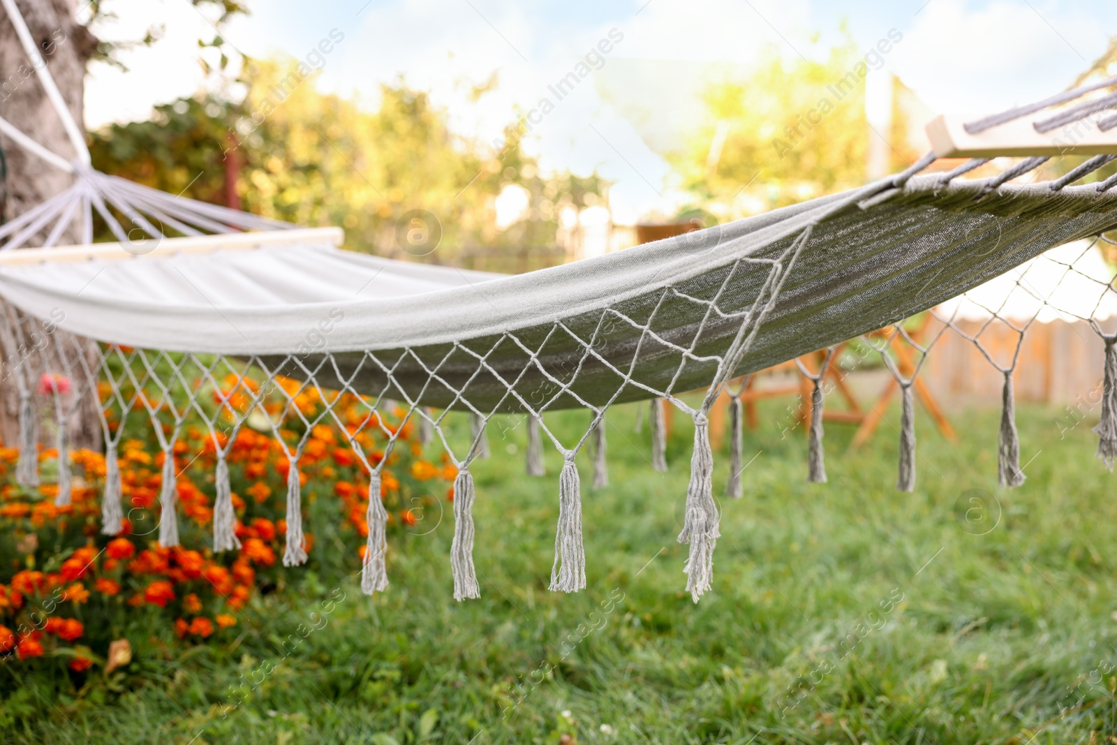 Photo of Empty comfortable white hammock in garden, closeup