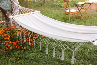 Photo of Empty comfortable white hammock in garden, closeup