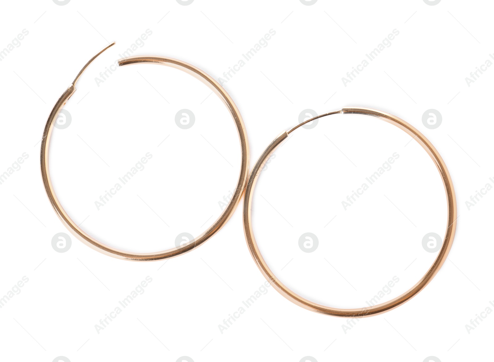 Photo of Stylish gold earrings isolated on white, top view