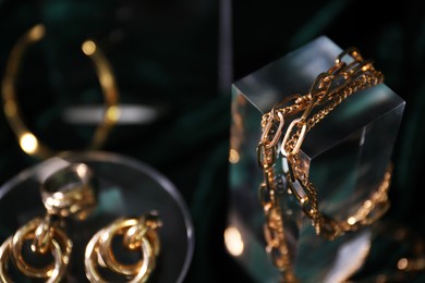 Photo of Stylish presentation of gold jewelry on dark background, selective focus. Space for text