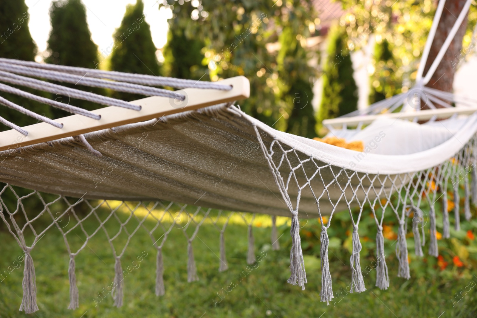 Photo of Comfortable hammock with pillow in garden, closeup