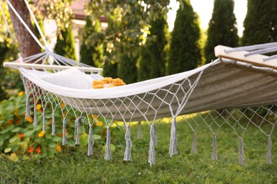 Photo of Comfortable hammock with pillow in garden, closeup