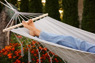 Photo of Senior woman resting in hammock outdoors, closeup