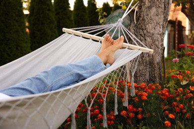 Photo of Senior woman resting in hammock outdoors, closeup