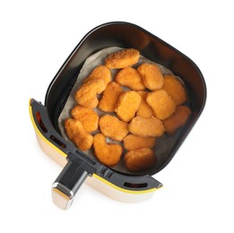 Photo of Air fryer basket with chicken nuggets isolated on white, top view