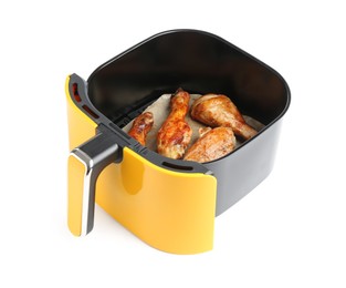 Photo of Air fryer basket with chicken drumsticks isolated on white